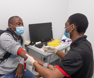 Kabelo Mabeleng prepares Duglas Netshidzivhani for a vaccine trial at the Aurum Institute Rustenberg, South Africa.