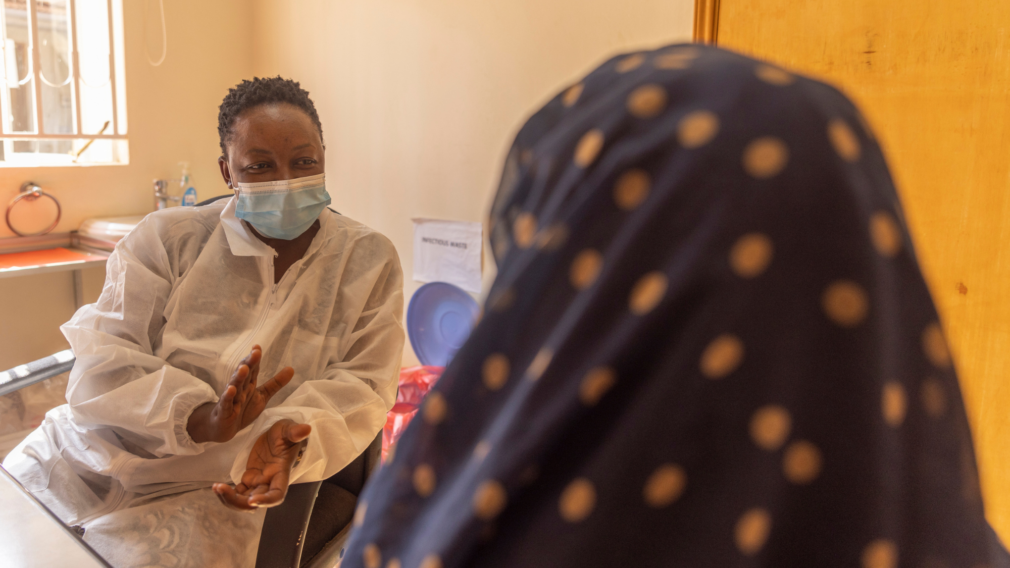 Angela Nansere with a patient at Masaka Laboratory in July 2022. Credit: Mwangi Kirubi
